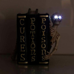 Livre avec corbeau ou squelette